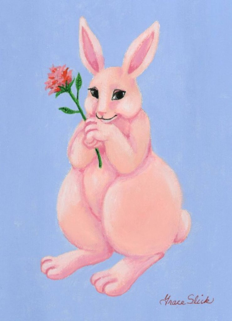 a pink rabbit holding a flower