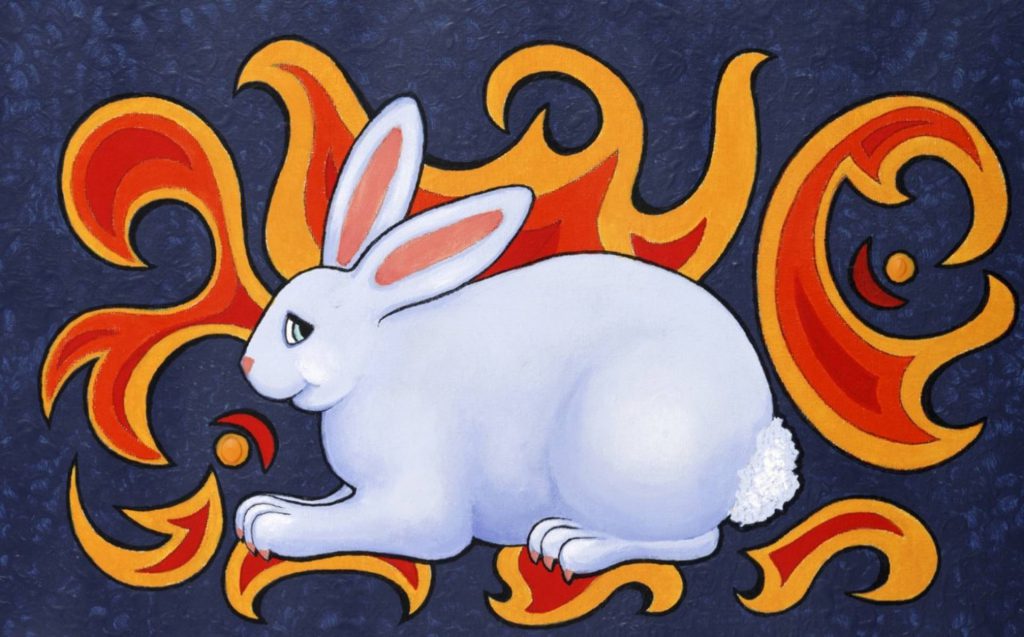 a white rabbit with orange flames